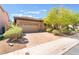 Home with a two-car garage, manicured landscaping, brick paver driveway and mature landscaping at 9025 Loggers Mill Ave, Las Vegas, NV 89143