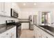 Well-lit kitchen featuring stainless appliances and ample white cabinetry at 9025 Loggers Mill Ave, Las Vegas, NV 89143