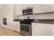 Bright kitchen features stainless steel appliances, granite counters and white cabinets at 9025 Loggers Mill Ave, Las Vegas, NV 89143