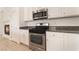 Bright kitchen features stainless steel appliances, granite counters and white cabinets at 9025 Loggers Mill Ave, Las Vegas, NV 89143