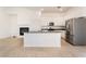 Bright kitchen features granite island, stainless steel appliances, and white cabinets at 9025 Loggers Mill Ave, Las Vegas, NV 89143