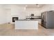 Bright kitchen features granite island, stainless steel appliances, and white cabinets at 9025 Loggers Mill Ave, Las Vegas, NV 89143