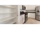 Open kitchen view featuring stainless steel appliances and pantry at 9025 Loggers Mill Ave, Las Vegas, NV 89143