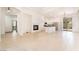 Spacious living room featuring tile floors, high ceilings, fireplace, and access to kitchen at 9025 Loggers Mill Ave, Las Vegas, NV 89143