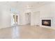 Bright living room featuring tile floors, fireplace, and entry to the home at 9025 Loggers Mill Ave, Las Vegas, NV 89143