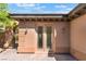 Outdoor patio area featuring brick pavers, neutral-colored walls, and an arched entry to a gated area at 9025 Loggers Mill Ave, Las Vegas, NV 89143