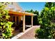 Covered patio with outdoor furniture and lush, mature landscaping at 9355 W Viking Rd, Las Vegas, NV 89147
