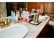 Bathroom features a vanity with dual sinks, elegant countertop decor, and a cheerful, floral motif at 9355 W Viking Rd, Las Vegas, NV 89147