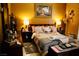 Bedroom featuring a queen bed, side tables with lamps, and dresser with a mirror at 9355 W Viking Rd, Las Vegas, NV 89147