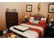 Cozy bedroom with a comfortable bed, dark wood dresser, and stylish decor at 9355 W Viking Rd, Las Vegas, NV 89147