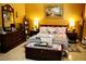 Elegantly furnished bedroom with warm color palette, decorative pillows, and stylish furniture at 9355 W Viking Rd, Las Vegas, NV 89147