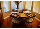 Bright dining area featuring a round wooden table with decorative place settings, set beneath a window at 9355 W Viking Rd, Las Vegas, NV 89147