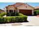 Charming single-story home featuring a well-manicured front yard and a wood-paneled two-car garage at 9355 W Viking Rd, Las Vegas, NV 89147