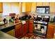 Cozy kitchen with wood cabinets, stainless steel appliances and a sunlit window at 9355 W Viking Rd, Las Vegas, NV 89147