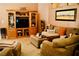 Inviting living room with plush sofas, a wooden entertainment center, and warm, neutral tones at 9355 W Viking Rd, Las Vegas, NV 89147