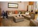 Spacious living room featuring a large sectional sofa, ottoman, and plush carpeting at 9355 W Viking Rd, Las Vegas, NV 89147