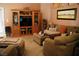Cozy living room featuring built-in shelving, comfortable seating, and plush ottoman at 9355 W Viking Rd, Las Vegas, NV 89147