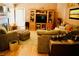 Spacious living room with an entertainment center, plush seating, and decorative accents creating a warm atmosphere at 9355 W Viking Rd, Las Vegas, NV 89147