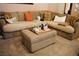 Comfortable living room features a large sectional sofa, ottoman, and plush carpeting at 9355 W Viking Rd, Las Vegas, NV 89147