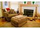 Cozy living room features comfortable seating near a fireplace with decorative elements and wood laminate flooring at 9355 W Viking Rd, Las Vegas, NV 89147