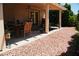 Charming covered patio with an outdoor dining set, perfect for entertaining at 9355 W Viking Rd, Las Vegas, NV 89147