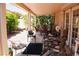 Relaxing covered patio with comfortable seating surrounded by lush greenery at 9355 W Viking Rd, Las Vegas, NV 89147