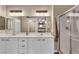 Bright bathroom featuring double sinks with a glass-enclosed shower, providing a spa-like experience at 9431 Mad Dog St, Las Vegas, NV 89178