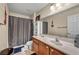 Cozy bathroom featuring a wooden vanity and shower with curtain at 9431 Mad Dog St, Las Vegas, NV 89178