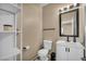 Modern bathroom featuring a sink, toilet and storage shelves at 9431 Mad Dog St, Las Vegas, NV 89178