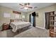 Cozy bedroom with a ceiling fan, closet, and an exterior door at 9431 Mad Dog St, Las Vegas, NV 89178