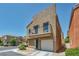 Exterior view of home with balcony and one-car garage, and desert landscaping at 9431 Mad Dog St, Las Vegas, NV 89178