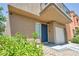 Stucco house with blue front door, one-car garage, and low-maintenance landscaping at 9431 Mad Dog St, Las Vegas, NV 89178