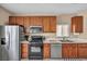 Charming kitchen with wood cabinets, stainless steel appliances, and tile flooring at 9431 Mad Dog St, Las Vegas, NV 89178