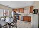 Open kitchen features stainless steel appliances, wood cabinets, and a spacious dining area at 9431 Mad Dog St, Las Vegas, NV 89178