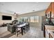 Open-concept living and kitchen area with large windows and a ceiling fan at 9431 Mad Dog St, Las Vegas, NV 89178