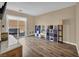 Living room area with laminate flooring and access to backyard via sliding doors at 9431 Mad Dog St, Las Vegas, NV 89178