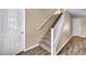 Carpeted staircase featuring white banister and hardwood floors at 9431 Mad Dog St, Las Vegas, NV 89178
