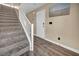 Carpeted stairs leading to a modern front door and decorative beach art at 9431 Mad Dog St, Las Vegas, NV 89178