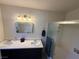Bathroom featuring double sinks, dark cabinets, and a glass shower stall at , Las Vegas, NV 89110