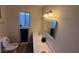 A compact bathroom features bright lighting, a sink, and frosted glass window at , Las Vegas, NV 89110