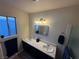 Bathroom featuring double sinks, dark cabinets, and ample lighting at , Las Vegas, NV 89110