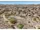 Wide aerial view of a community near a golf course, and desert landscaping at 1 Ibis Ct, Henderson, NV 89052