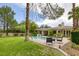 Spacious backyard featuring a pool, patio, lush landscaping, and seating area at 10156 Kearney Hill Pl, Las Vegas, NV 89144