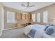 Sunlit bedroom featuring a built-in desk with shelving and an inviting window view, creating an ideal workspace at 10156 Kearney Hill Pl, Las Vegas, NV 89144