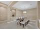 Bright dining room featuring a modern chandelier and seating for eight at 10156 Kearney Hill Pl, Las Vegas, NV 89144