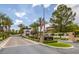Gated community entrance with lush landscaping and an American flag at 10156 Kearney Hill Pl, Las Vegas, NV 89144