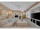 Bright living room with a large TV, comfortable seating, and backyard access at 10156 Kearney Hill Pl, Las Vegas, NV 89144