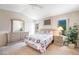 Inviting bedroom features a comfy bed, two windows with greenery, and matching dressers for ample storage at 1742 Ashburn Dr, North Las Vegas, NV 89032