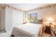Cozy bedroom featuring a window view, a comfortable bed, and a bedside table with a lamp at 1742 Ashburn Dr, North Las Vegas, NV 89032