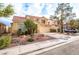 Two-story home with desert landscaping, an attached two-car garage, and a red tile roof at 1742 Ashburn Dr, North Las Vegas, NV 89032